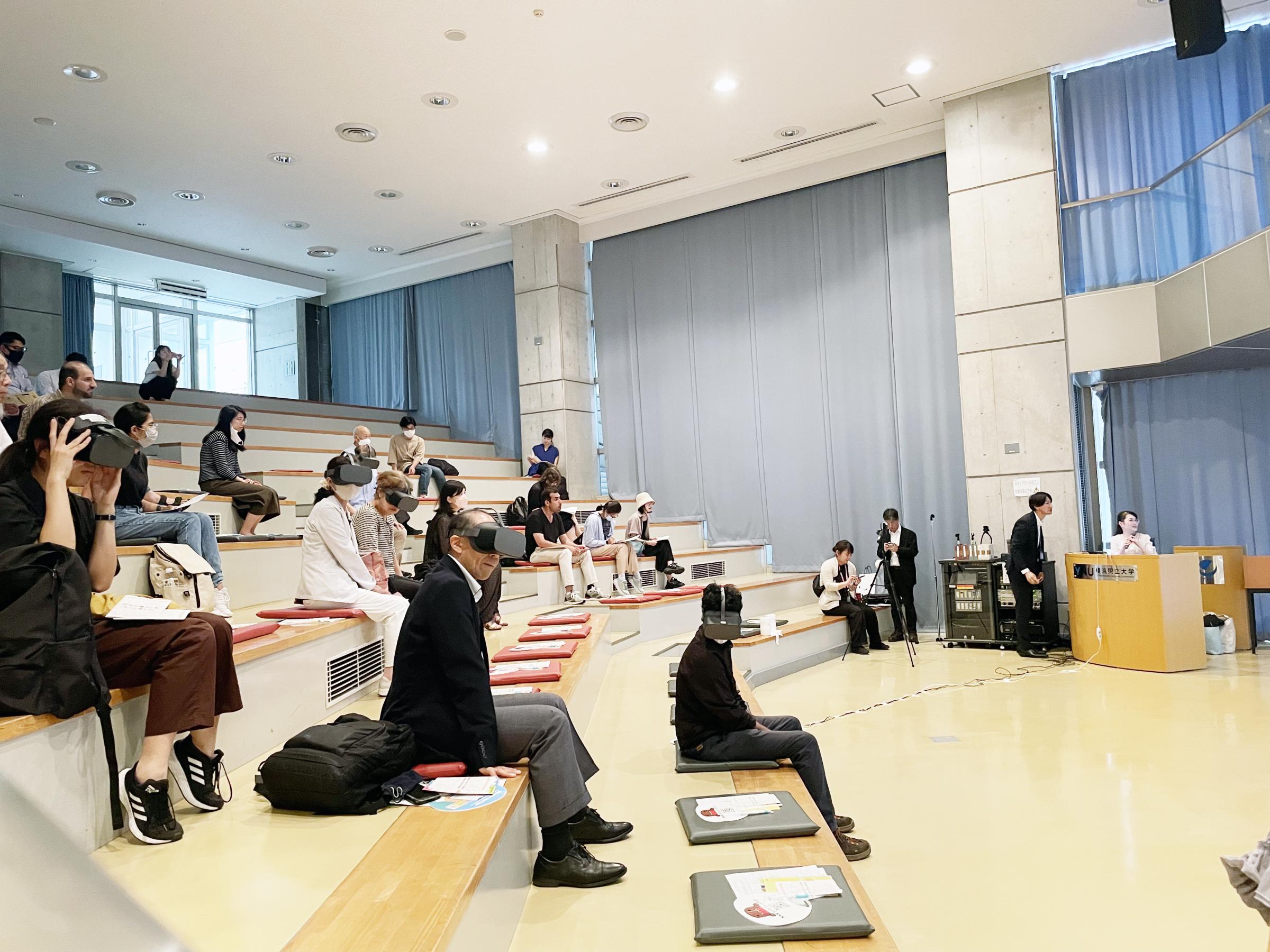 Participants wearing VR equipment and experiencing an earthquake