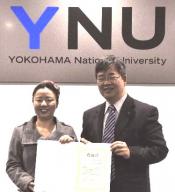 Executive Director Nakamura (right) presented Ms. Yang (left) a letter of appreciation